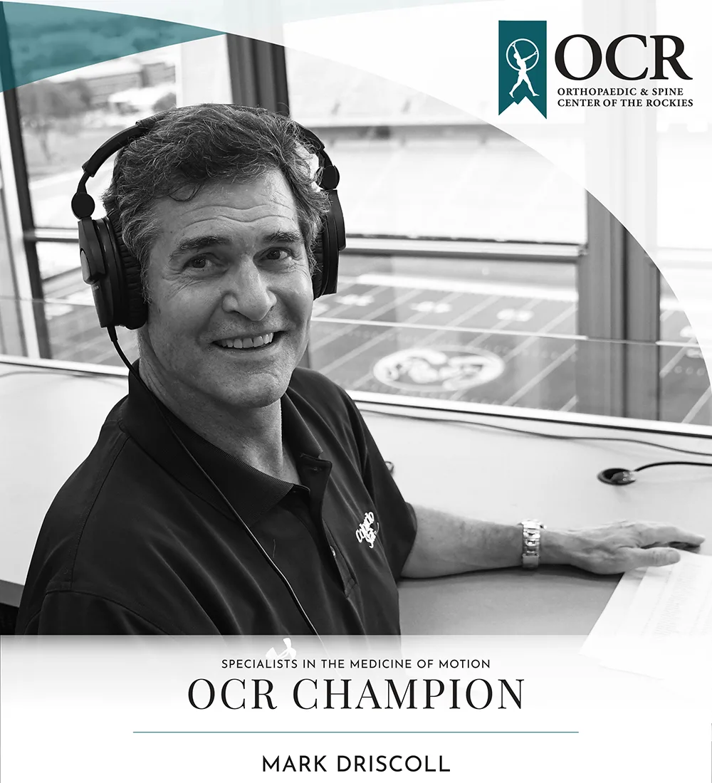 man announcing at football game, OCR logo, text that reads: Specialists in the medicine of motion, OCR Champion, Mark Driscoll