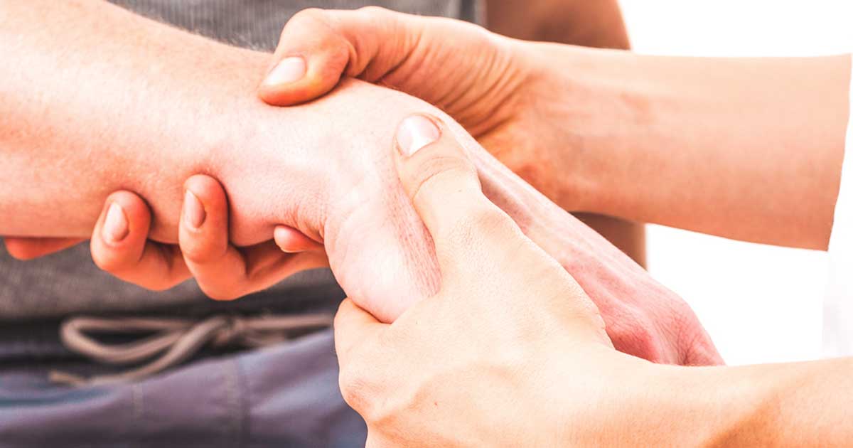 physician helping patient with injured hand