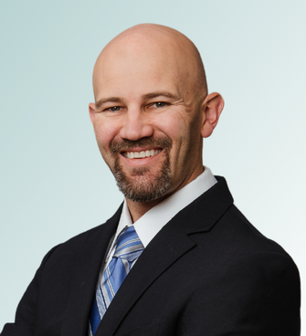 man smiling ,wearing a suit and tie