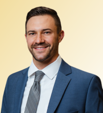 man smiling, wearing a tie and suit