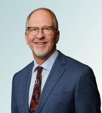 man smiling ,wearing a suit