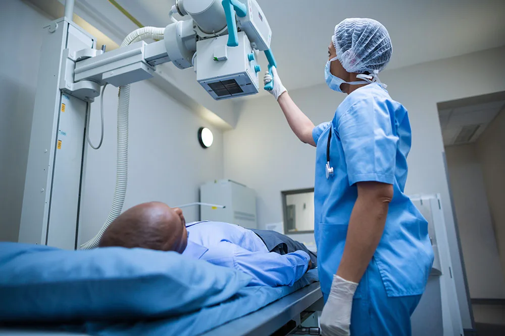 x-ray tech doing an x-ray on a patient