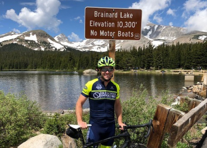 A man with his bike on a trail