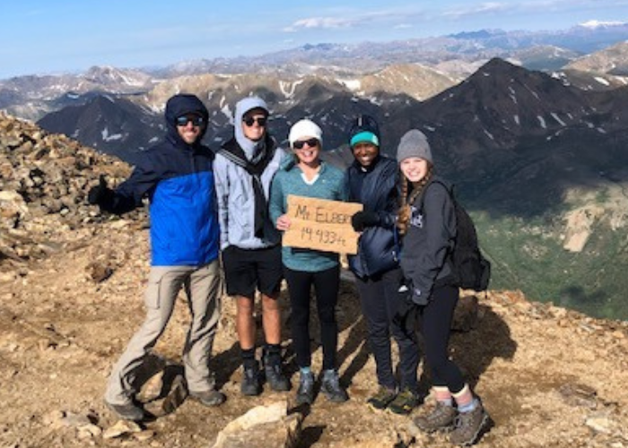 A family at the mountain top after a hike