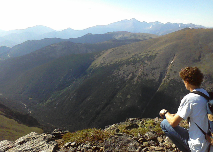 a man looking out over a mountain