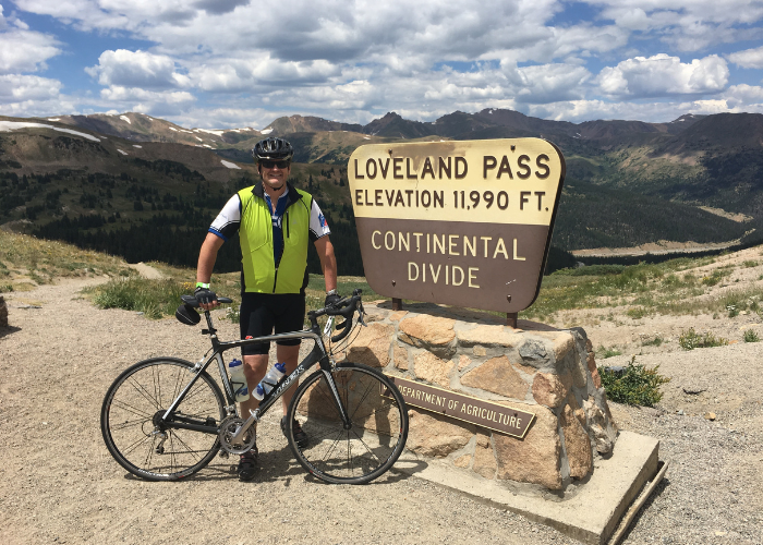 Dr. Beard standing with his bike on a trail