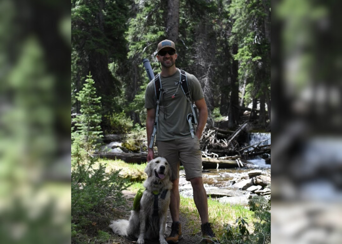 A man and his dog in the woods