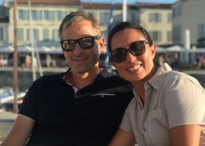 A man and woman in sunglasses pose for a picture together