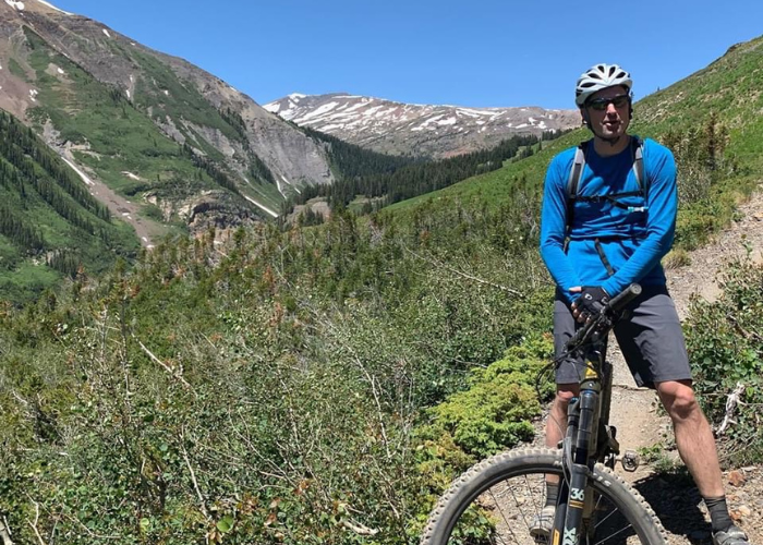 A man on a bike in the mountains