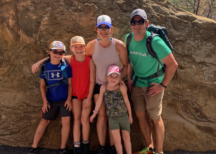 a family of 5 posing for a picture on a hike