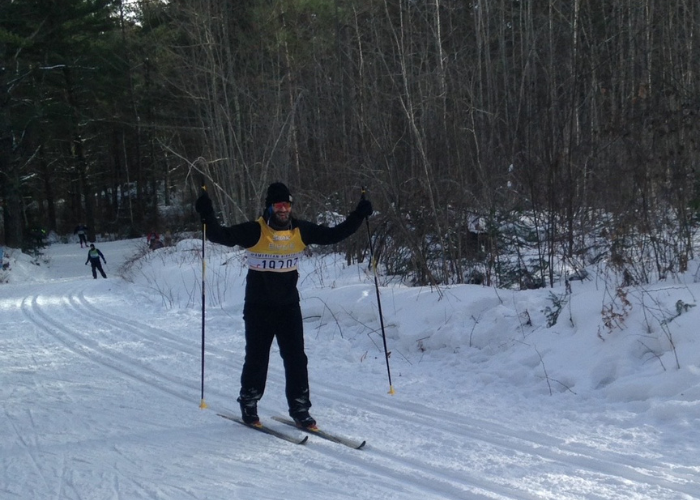 man skiing down a hill in a yellow shirt