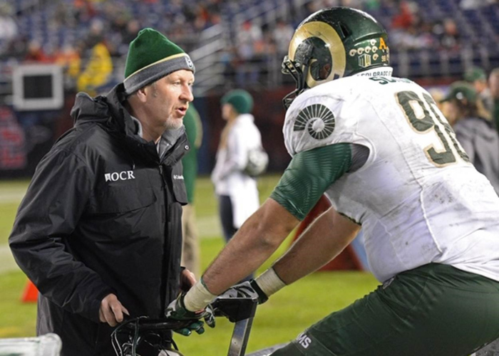 Dr. Trumper on the sidelines with an athlete