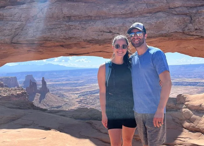 two people on a scenic hiking trail, smiling