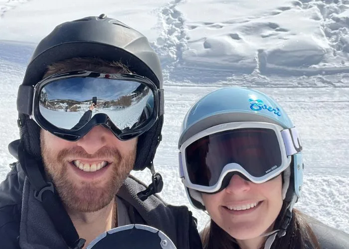 two people wearing skiing gear on a ski mountain