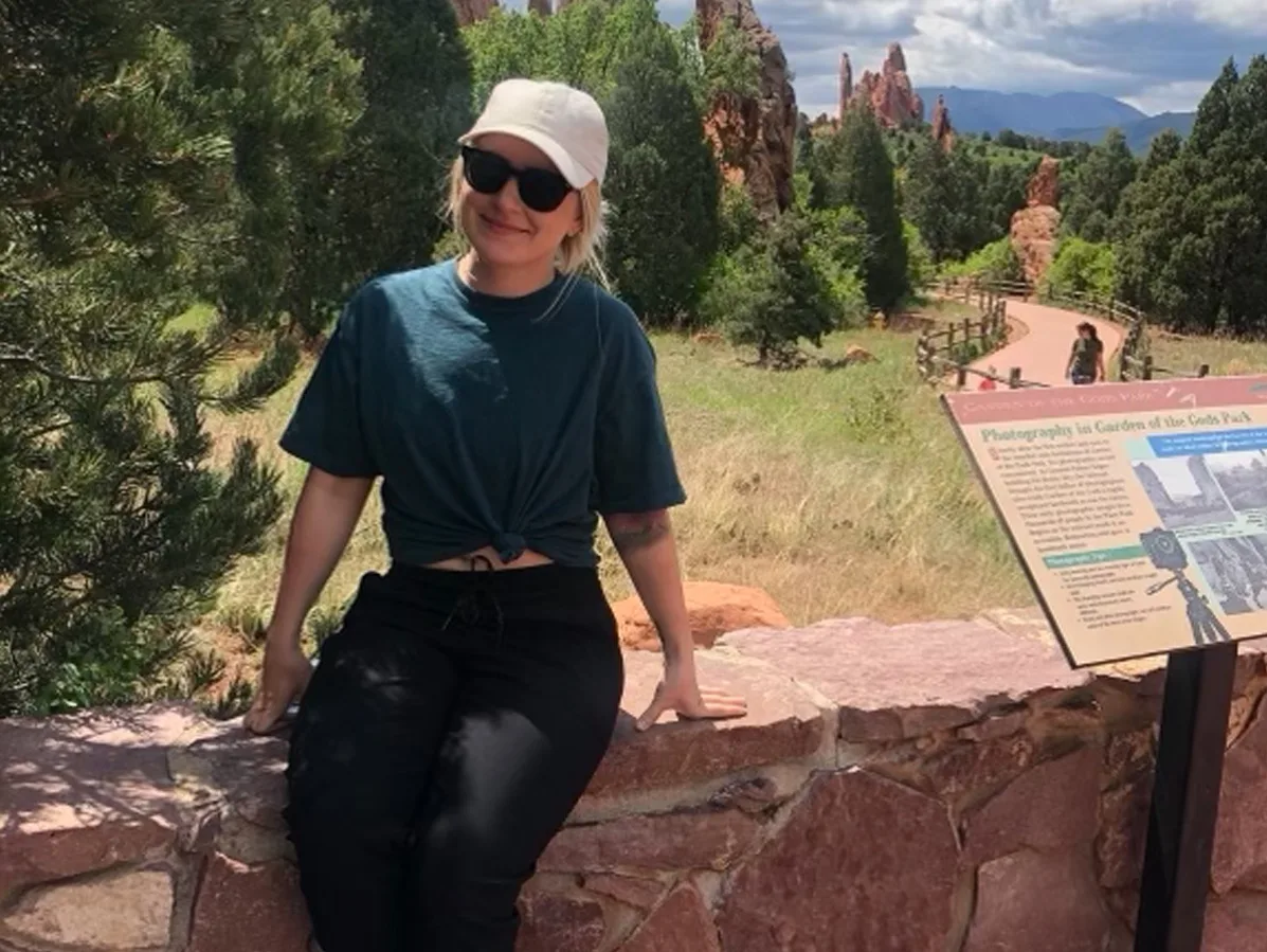 woman smiling with mountains in the background