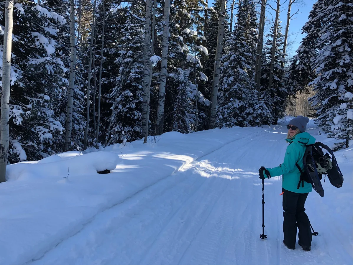 woman snowshoeing in the woods