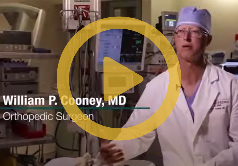 Dr. Cooney in an operating room with a play sign