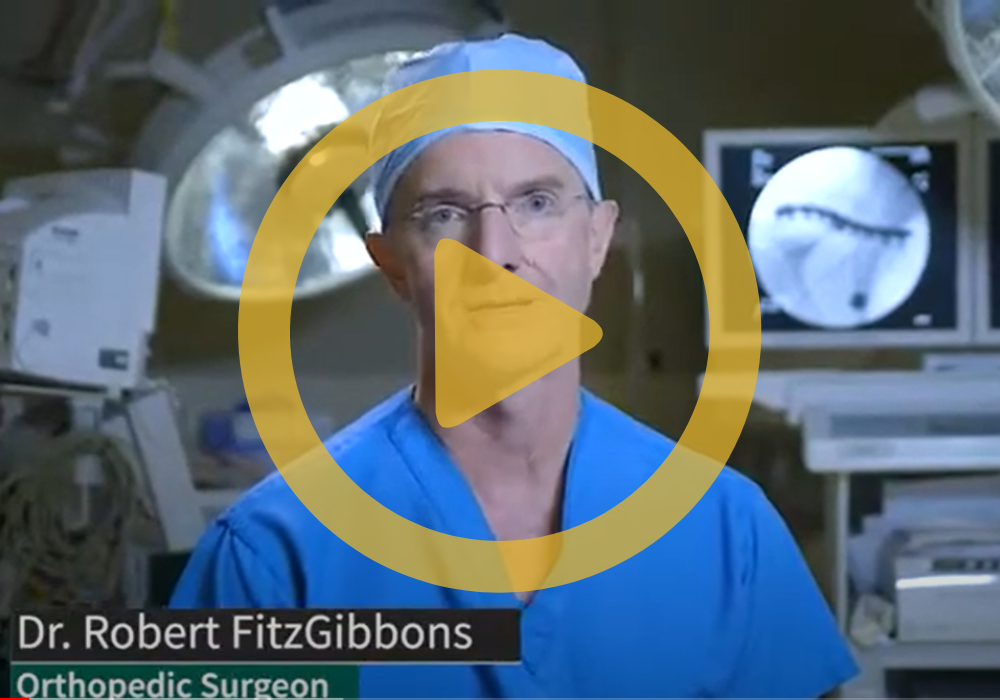 Dr. FitzGibbons in the operating room with a play button on top