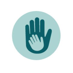 A circular icon with a light blue background featuring two overlapping hand silhouettes, one larger and dark blue, and the other smaller and white. The smaller hand is placed within the outline of the larger hand, symbolizing support or care.