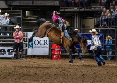 a man on a horse in an arena with the OCR banner behind him