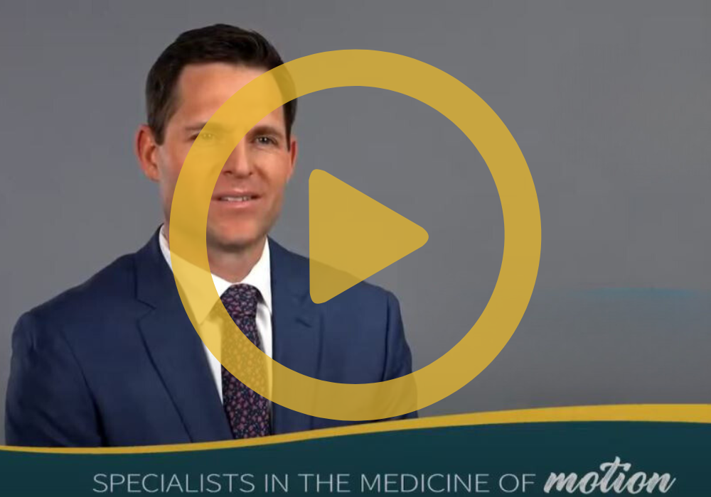 Dr. Schnell on a grey background with a yellow play button overlay