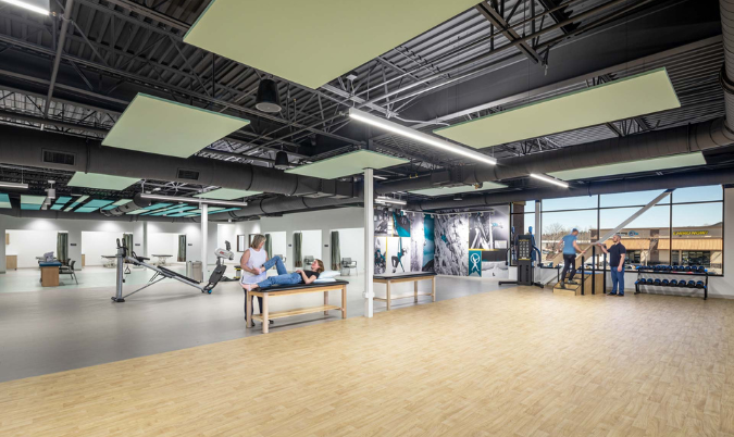 Wood floors with physical therapy equipment with mirrors and photography