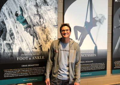 Craig Demartino standing in front of his plaque