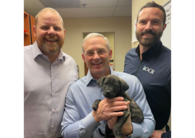 OCR team members holding puppies