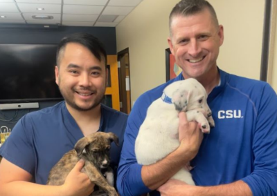 OCR team members holding puppies