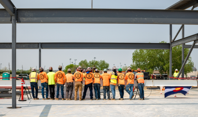 construction workers standing in front of a work site